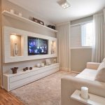 A niche for a TV made of plasterboard on the entire wall at the bottom of the shelf for dishes