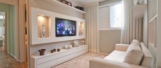 A niche for a TV made of plasterboard on the entire wall at the bottom of the shelf for dishes